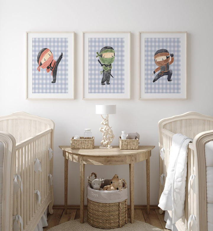 Ninja Set Of 3 Paintings in White Frame With Mount placed on a wall behind infant's beds for kids room