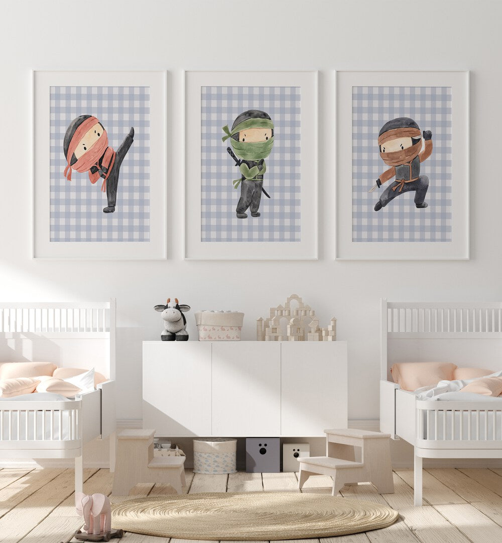 Ninja Set Of 3 Paintings in White Frame With Mount placed on a wall behind infant's bed for kids room