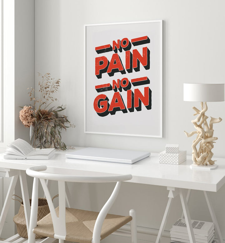 No Pain No Gain Quotes and Typography Posters in White Plain Frame placed on a wall behind a white study table