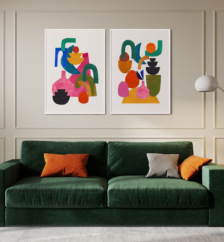Green sofa with colorful cushions in a room with abstract wall art.