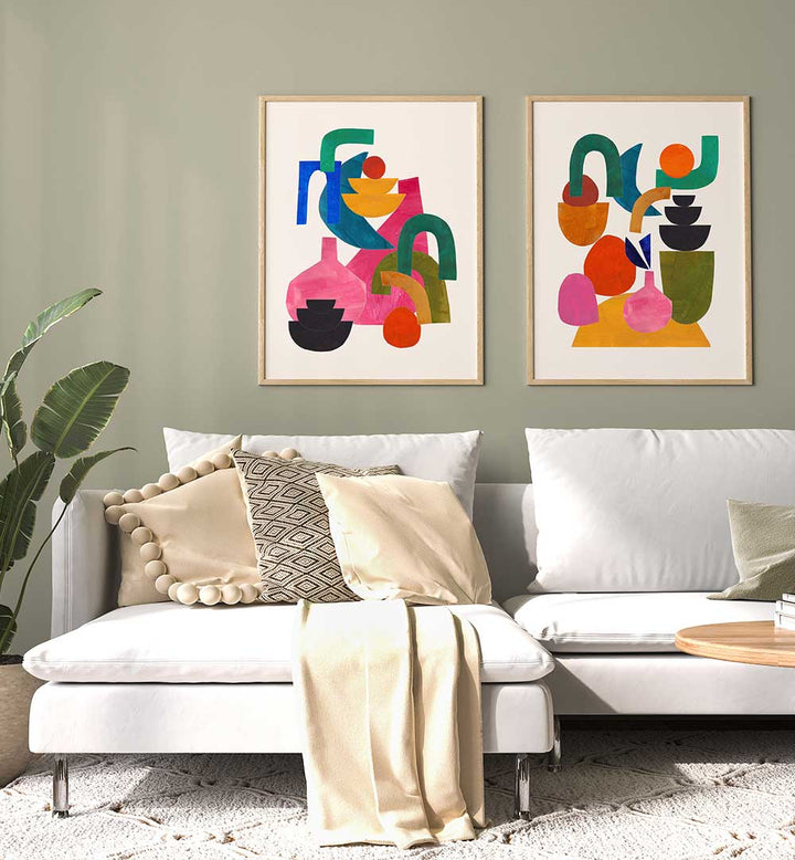 Living room with a white sofa, colorful abstract art on the wall, and a plant.
