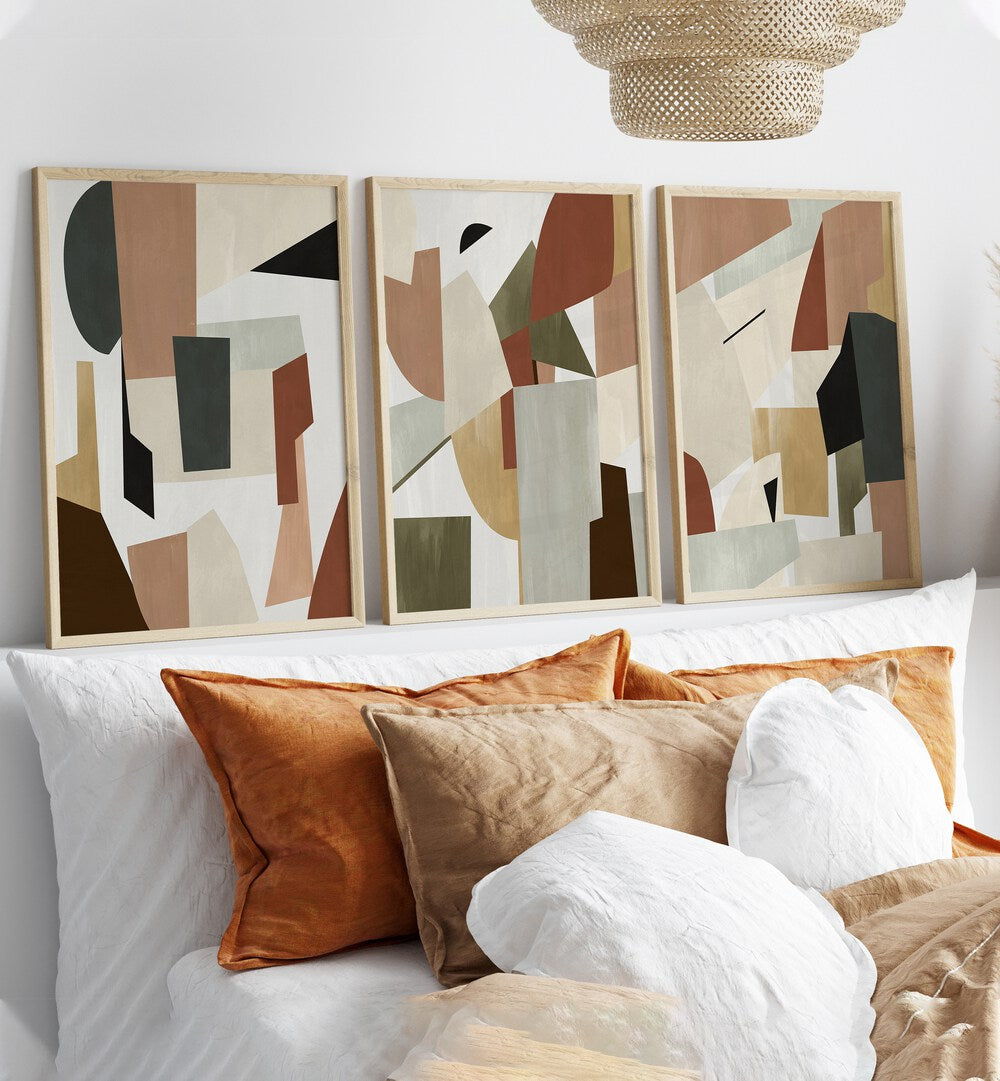 Nordic Shapes Set Set Of 3 Paintings in Oak Wood Plain Frame placed behind a bed for bedroom