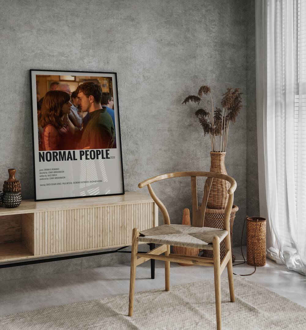 Normal People I Movie Posters in Black Plain Frame placed on a console behind a chair