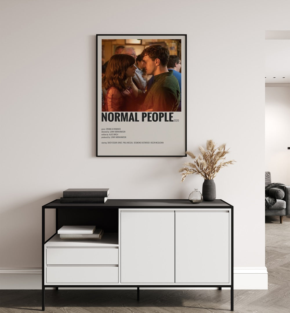 Normal People I Movie Posters in Black Plain Frame placed on a white wall behind a black and white table