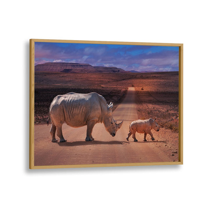 Majestic rhinos cross a road under a stunning sunset in our RHINOS CROSSING, PHOTOGRAPHY PRINTS collection.