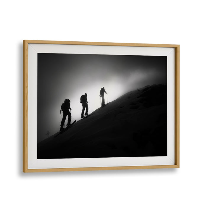 Framed STEP BY STEP, PHOTOGRAPHY PRINTS showcasing silhouetted skiers ascending a mountain, perfect for any art lover.