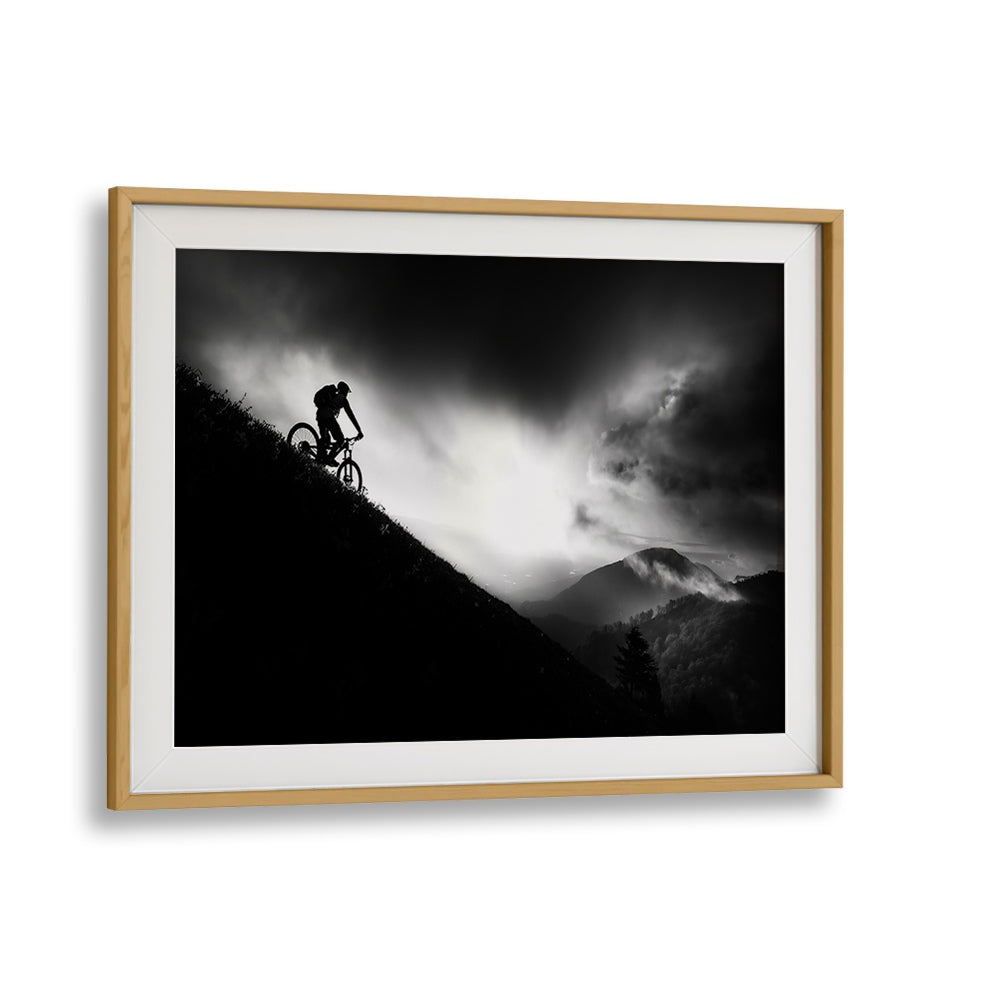 Silhouetted cyclist conquering a mountain at dawn, showcasing SUNRISE RIDE, PHOTOGRAPHY PRINTS for adventure lovers.