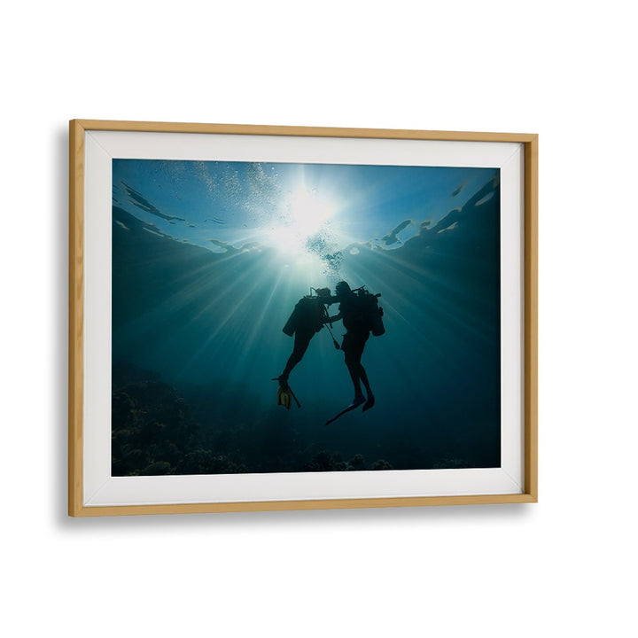 Underwater scene showcasing divers illuminated by sunlight, featuring TRUST ME, PHOTOGRAPHY PRINTS for art lovers.