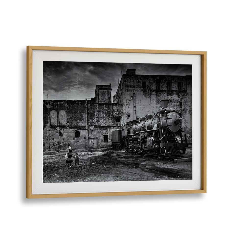Black-and-white TRAIN, PHOTOGRAPHY PRINTS showcasing a vintage locomotive in a gritty urban setting. Elevate your decor.