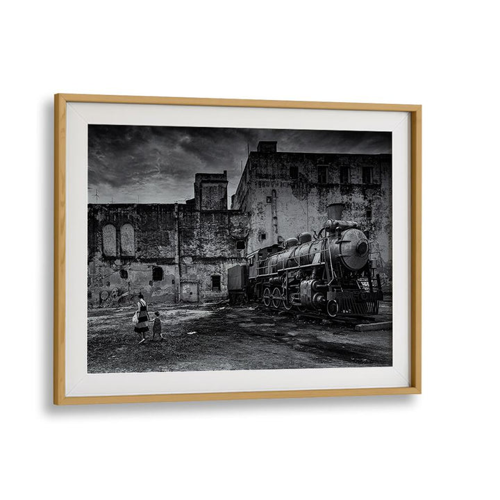 Black-and-white TRAIN, PHOTOGRAPHY PRINTS showcasing a vintage locomotive in a gritty urban setting. Elevate your decor.