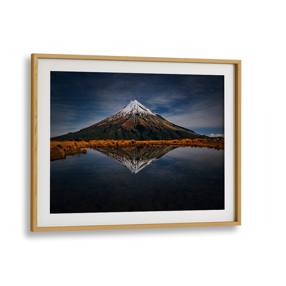 Majestic Mount Taranaki reflects under a starry sky in stunning photography prints, perfect for your collection.