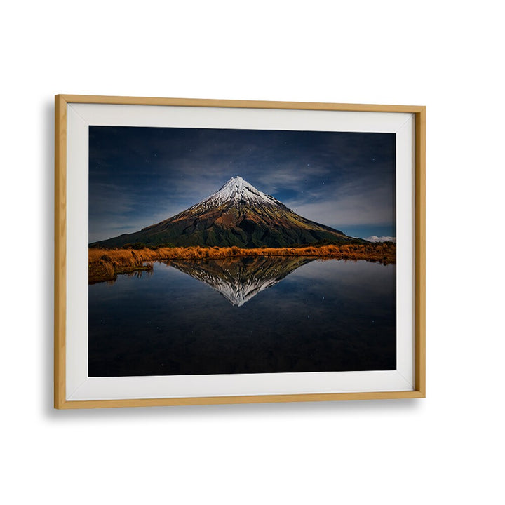 Majestic Mount Taranaki reflects under a starry sky in stunning photography prints, perfect for your collection.