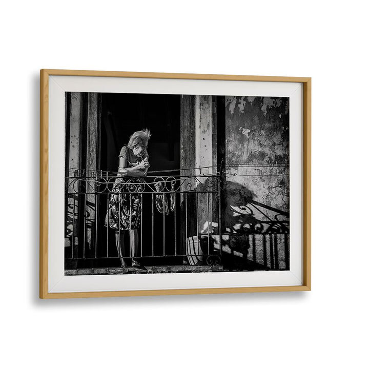 Elegant black and white HABANA STREET VI, PHOTOGRAPHY PRINTS showcasing urban life and emotion on a vibrant balcony.
