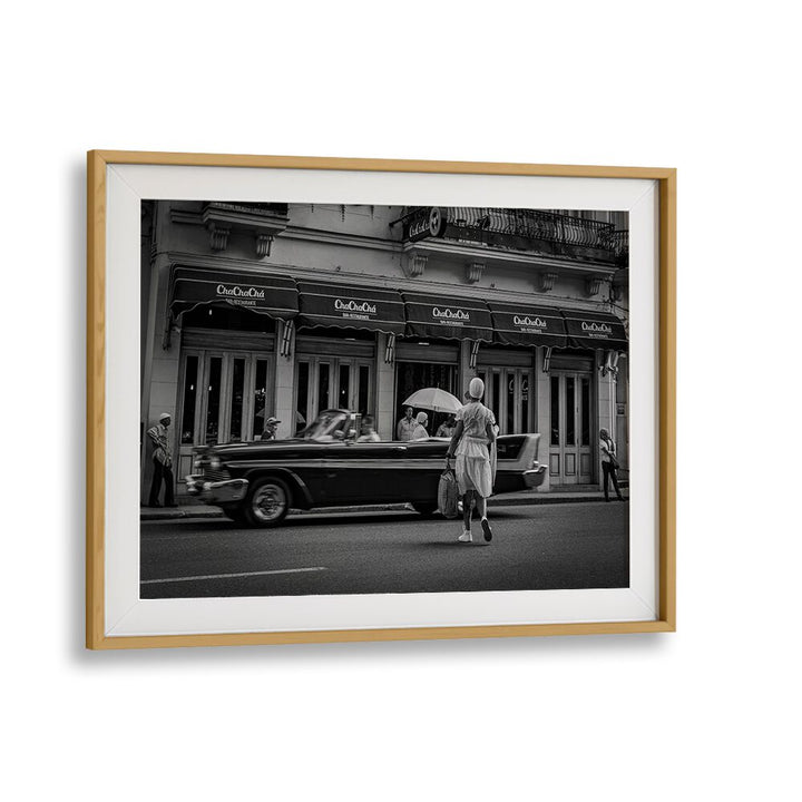 Explore urban life with HABANA STREET XI, PHOTOGRAPHY PRINTS, showcasing a timeless scene of classic cars and street culture.