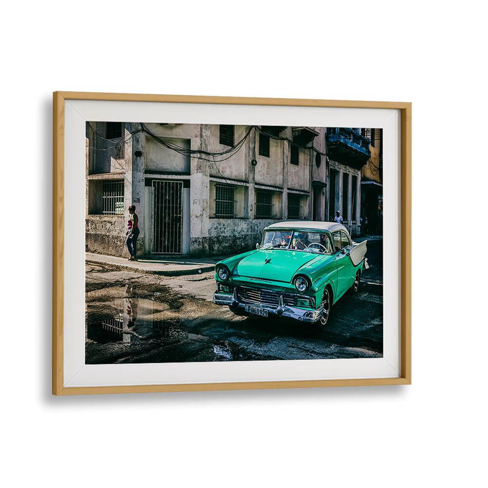 HABANA STREET IV, PHOTOGRAPHY PRINTS showcase a vibrant green classic car amidst urban scenery, capturing Cuban charm.
