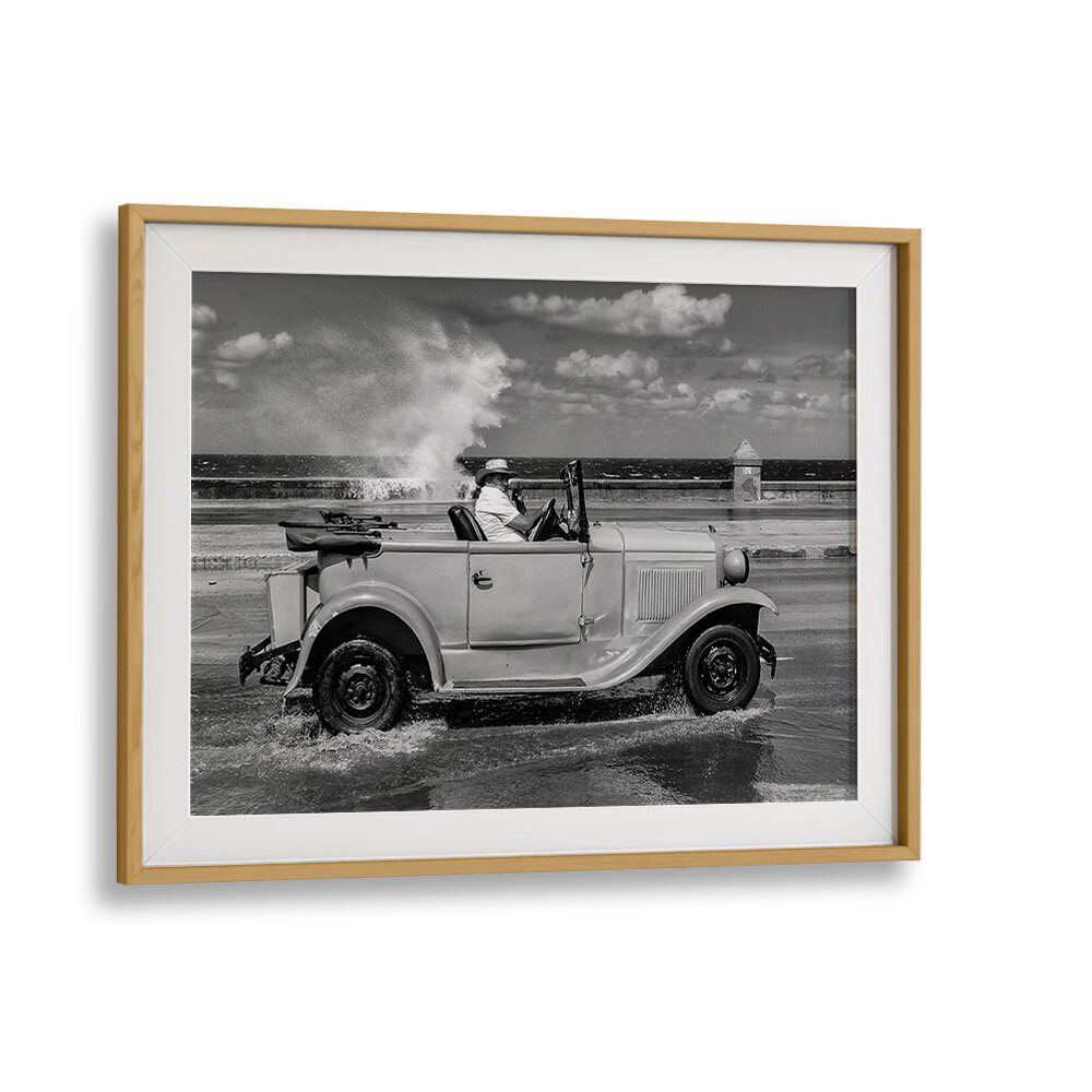 Classic car splashes through waves, capturing the spirit of urban life in MALECON, PHOTOGRAPHY PRINTS.