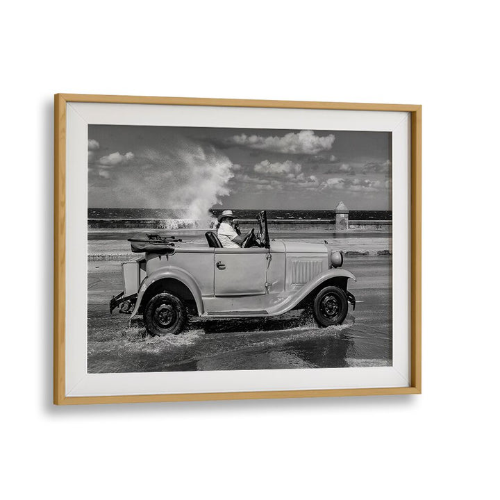 Classic car splashes through waves, capturing the spirit of urban life in MALECON, PHOTOGRAPHY PRINTS.