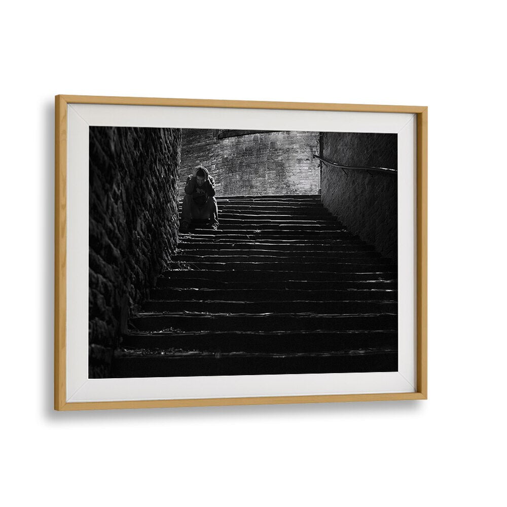 Emotional scene of solitude captured in "IN DESPAIR, PHOTOGRAPHY PRINTS," reflecting urban life's depth and story.