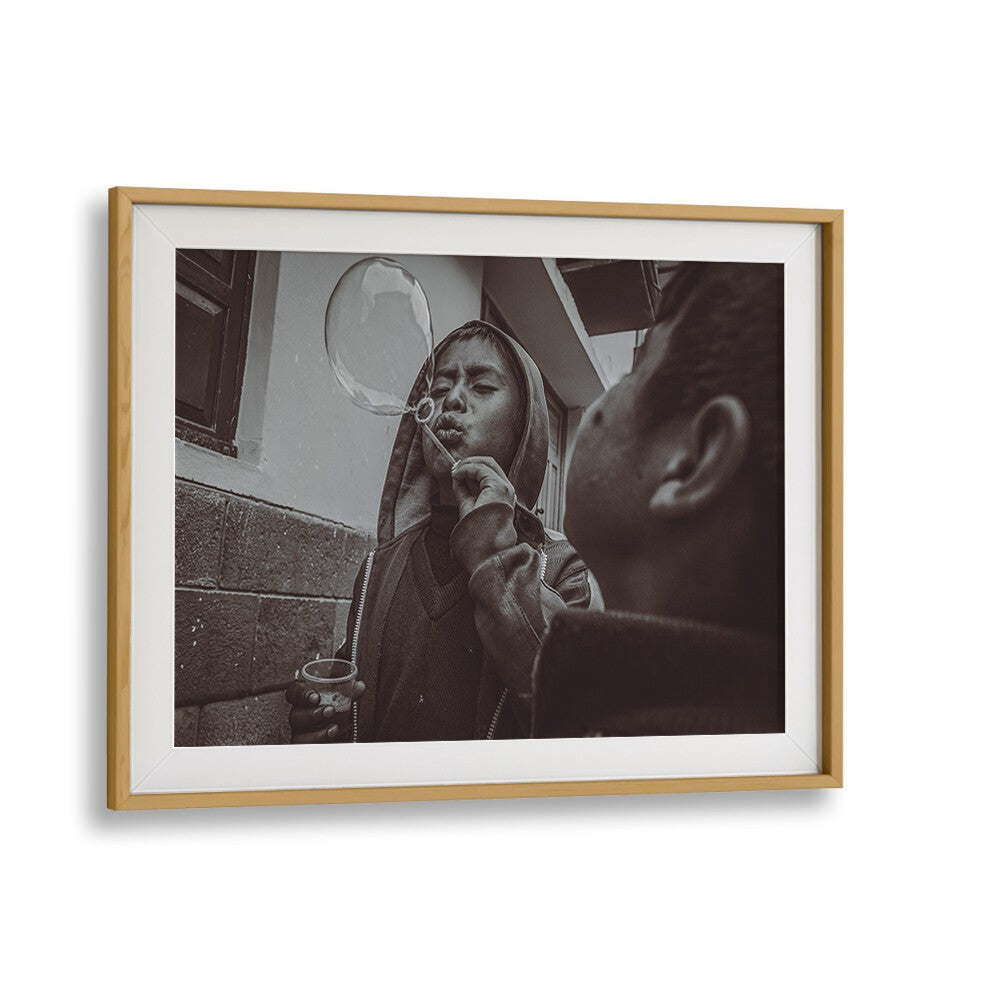 A child blowing a bubble captures the essence of urban life in CUSCO STREET, PHOTOGRAPHY PRINTS. Perfect for your collection.