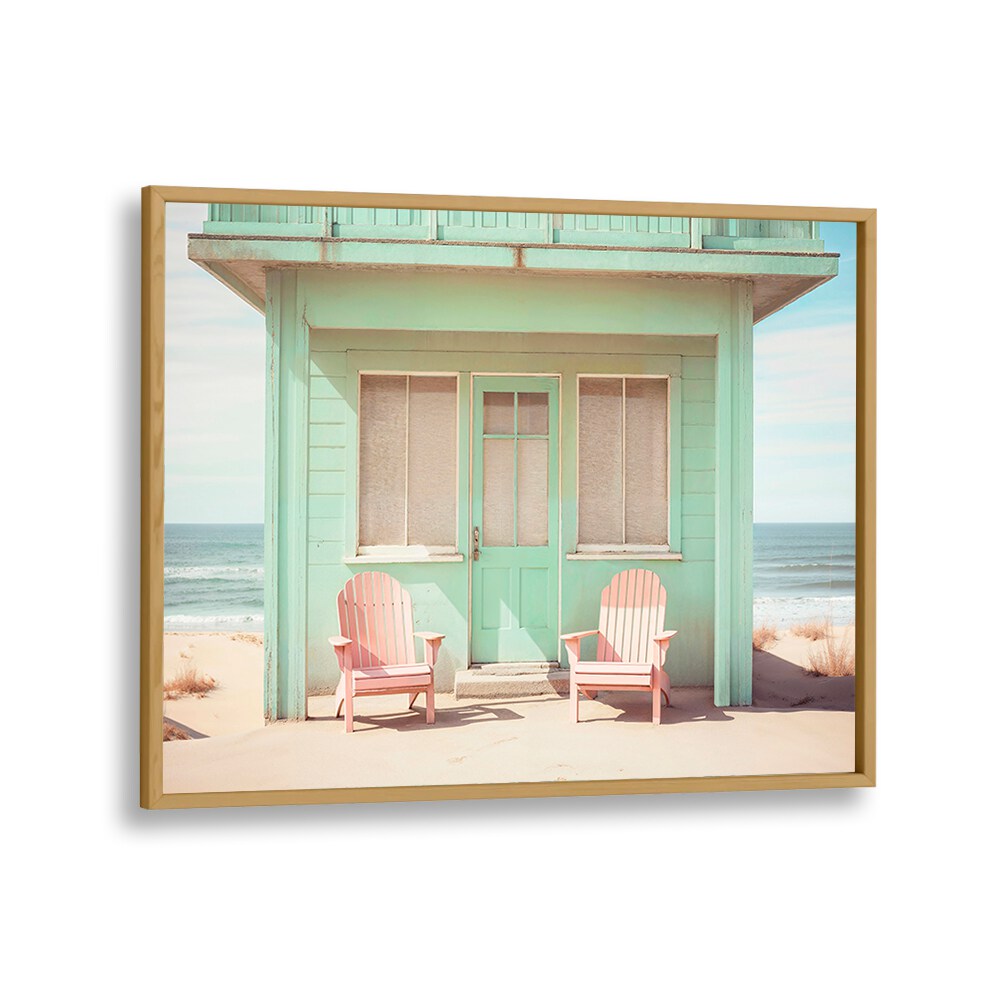 Pastel Perspectives beach paintings showcase a serene coastal scene with vibrant pink chairs and a charming mint cottage.