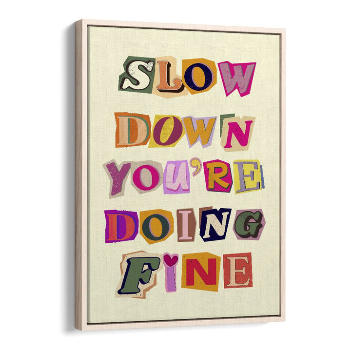 Framed art print featuring the motivational phrase "SLOW DOWN YOU'RE DOING FINE" in vibrant colors. Perfect for decor.