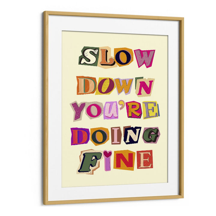 Colorful framed art print featuring "SLOW DOWN YOU'RE DOING FINE" for a cheerful home decor touch.