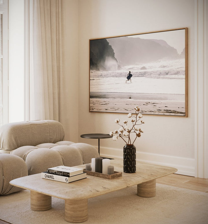 Oceans Call Beach Prints Coastal Wall Art in Oak Wood Plain Frame placed on a wall beside a sofa