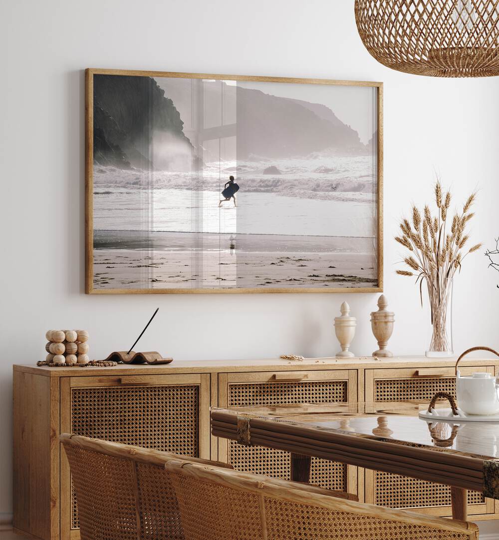 Oceans Call Beach Prints Coastal Wall Art in Oak Wood Plain Frame placed on a wall behind a console table 