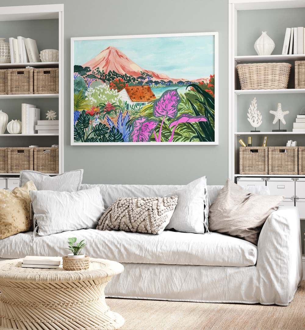 Ometepe By Sarah Gesek Landscape Art Prints in White Plain Frame placed on the wall behind a sofa