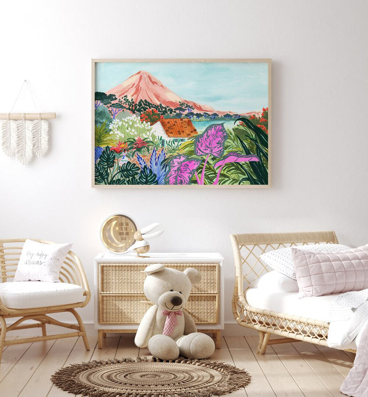 Ometepe By Sarah Gesek Landscape Art Prints in Oak Wood Plain Frame placed on the wall behind a table in a kids room