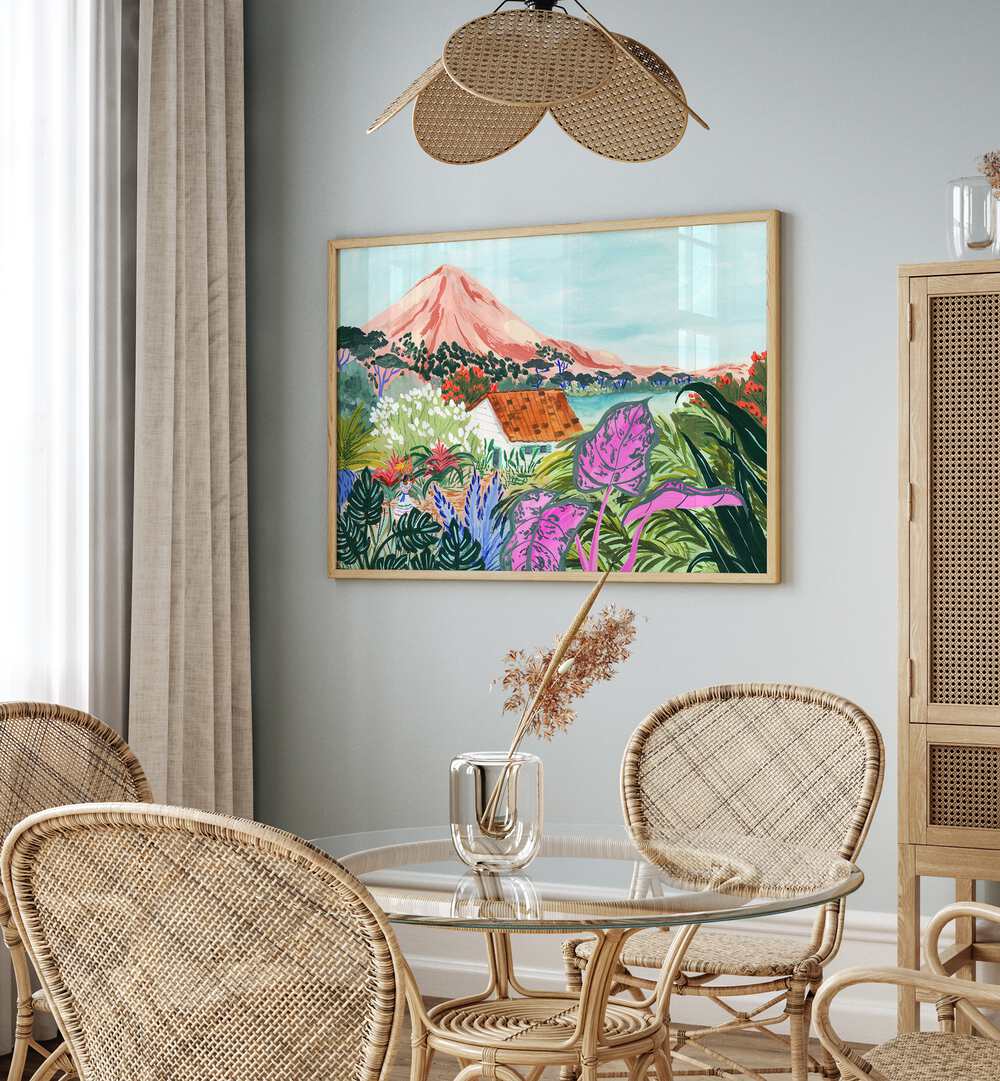 Ometepe By Sarah Gesek Landscape Art Prints in Oak Wood Plain Frame placed on a wall behind a dining table for dining area