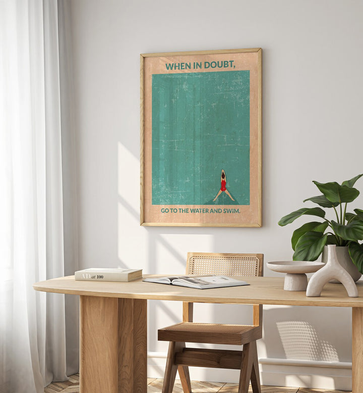 Open Water Standard Wall Art Sports Posters in Oak Wood Plain Frame placed on a wall behind a study table