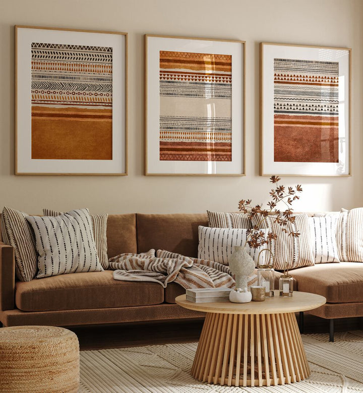 Organic Rug Patterns Set Of 3 Paintings in Oak Wood Frame With Mount placed on a living room wall behind a sofa