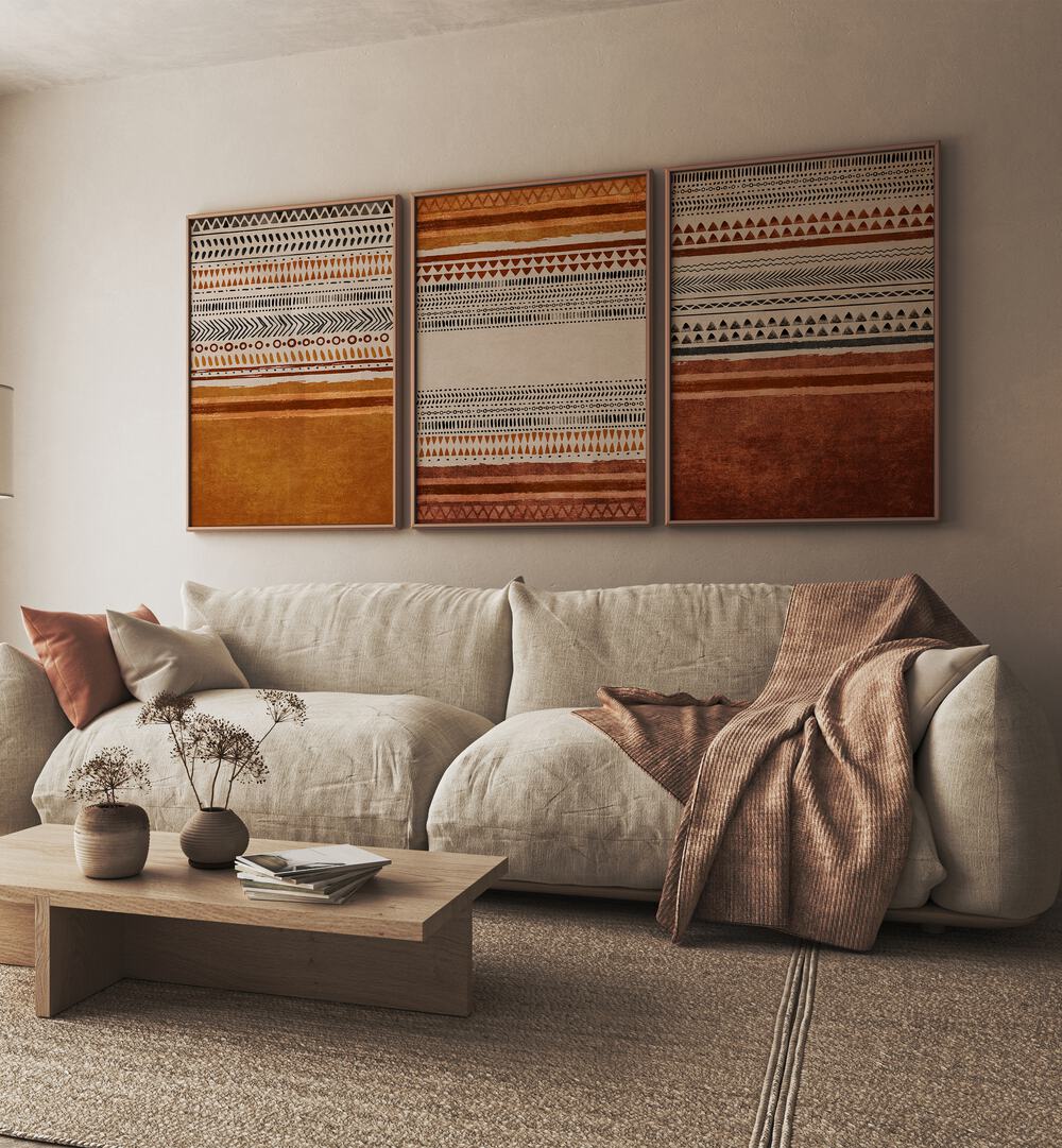 Organic Rug Patterns Set Of 3 Paintings in Oak Wood Plain Frame placed on a living room wall behind a sofa