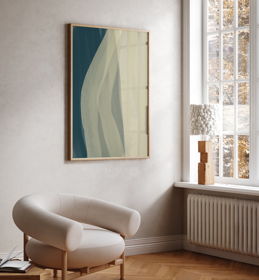 Otium by Yopie Studio Abstract Paintings Abstract Art Prints in Oak Wood Plain Frame placed on a wall beside a window and behind a chair