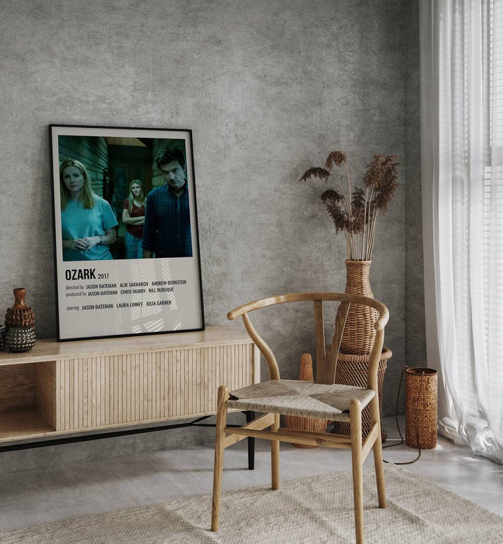 Ozark 2017 Movie Posters in Black Plain Frame placed on a table beside oakwood chair