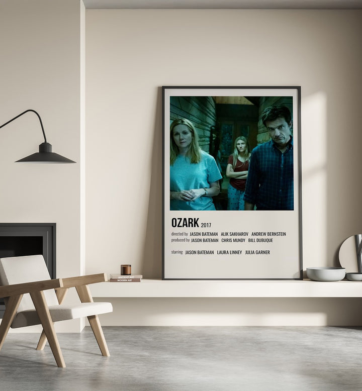 Ozark 2017 Movie Posters in Black Plain Frame place on a wall behind a chair beside lamp