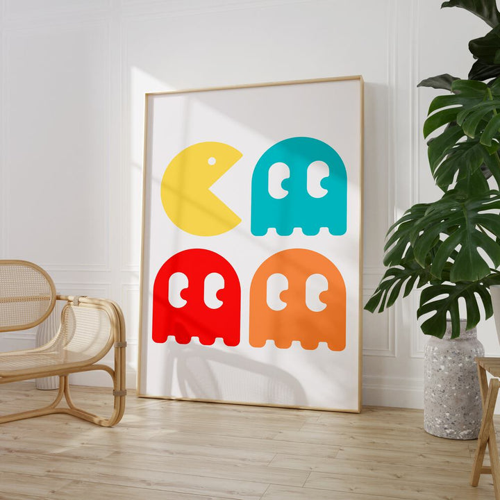 Pacman Continue Gaming Art Painting Artwork in plain oakwood frame beside a chair