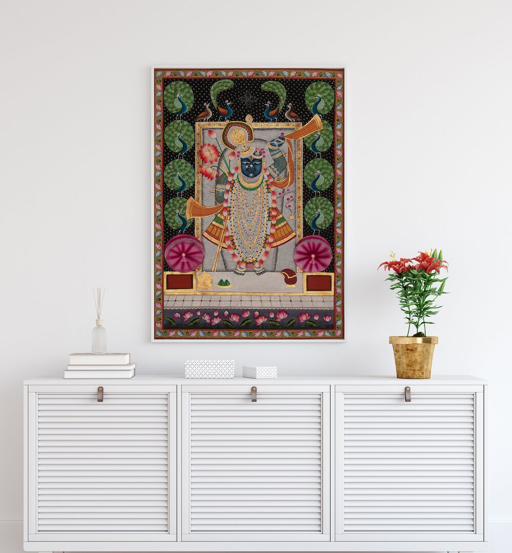 Pichwai Art II Indian Art Painting Artwork in White Plain Frame Placed on a White Wall above a white cabinet / console Table