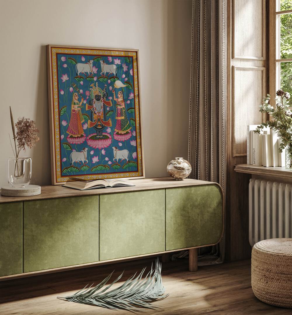 Pichwai Art IV Indian Art Painting Artwork oakwood floater frame on green console table beside a window