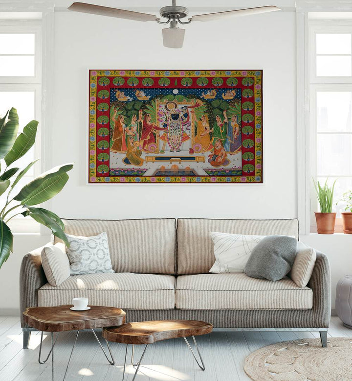 Pichwai Art VI Indian Art Painting Artwork in White Plain Frame placed on a white wall behind a Beige Sofa in the Living Room