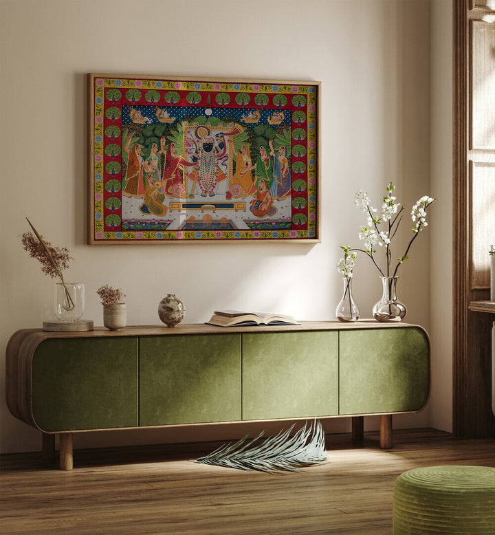 Pichwai Art VI Indian Art Painting Artwork in Oak Wood Plain Frame placed on a Cream Colored Wall above a Green Wooden Cabinet /Console table in the Living Room