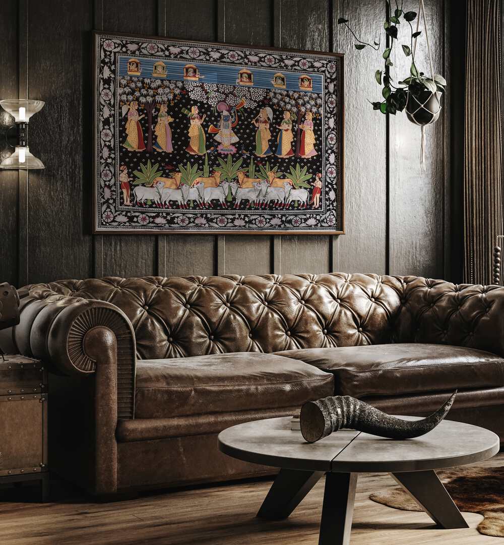 Pichwai Art VII Indian Art Painting Artwork in Dark Wood Plain Frame placed on a Wooden Textured Wall next to a Brown Leather Sofa in the Living Room