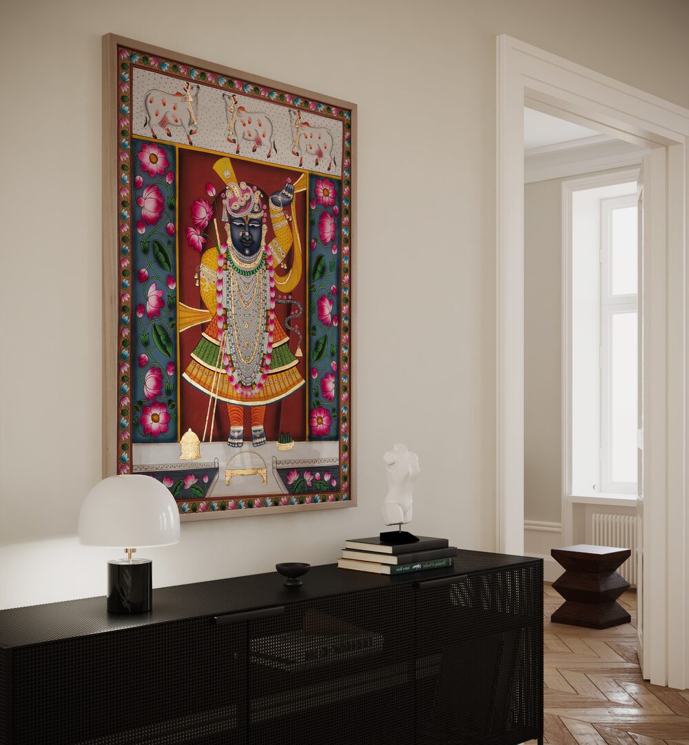 Pichwai I Indian Art Painting Artwork in oakwood plain frame above black console table on a white wall