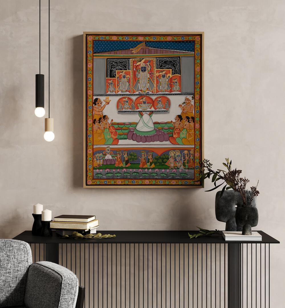 Pichwai II Indian Art Painting Artwork in Oak Wood Floater Frame placed on a Cream Colored Wall above a console table