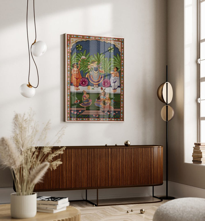 Pichwai Indian Art Painting Artwork in oakwood floater frame above a console table on off white wall