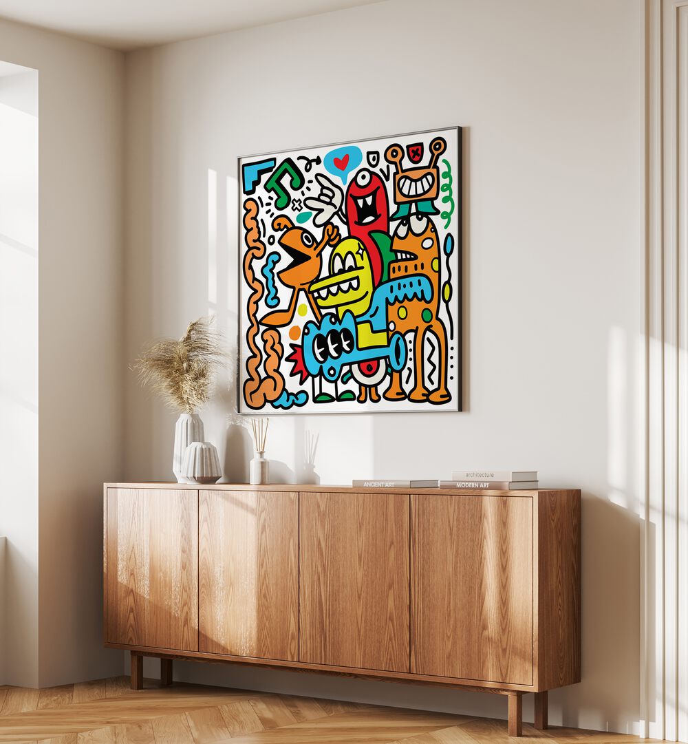 Pop Music Monsters Comic Art Artwork in Black Plain Frame placed on a cream colored wall above a wooden console table in the drawing room