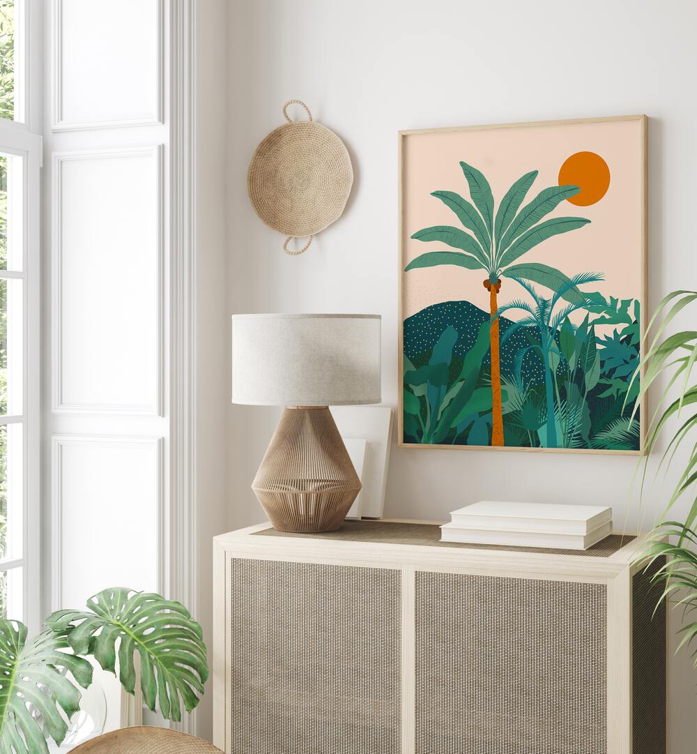 Palm Vibes By Uma Gokhale Botanical Art Prints in Oak Wood Plain Frame on a white wall behind a table