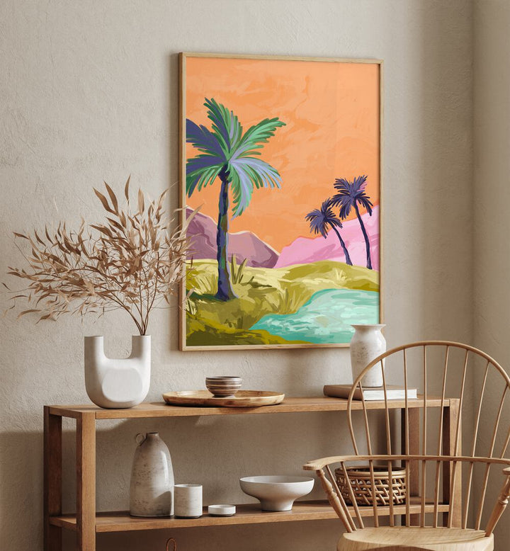 Palmtrees By Goed Blauw Landscape Art Prints in Oak Wood Plain Frame placed on a Cream Colored Wall above a Table in the Drawing Room