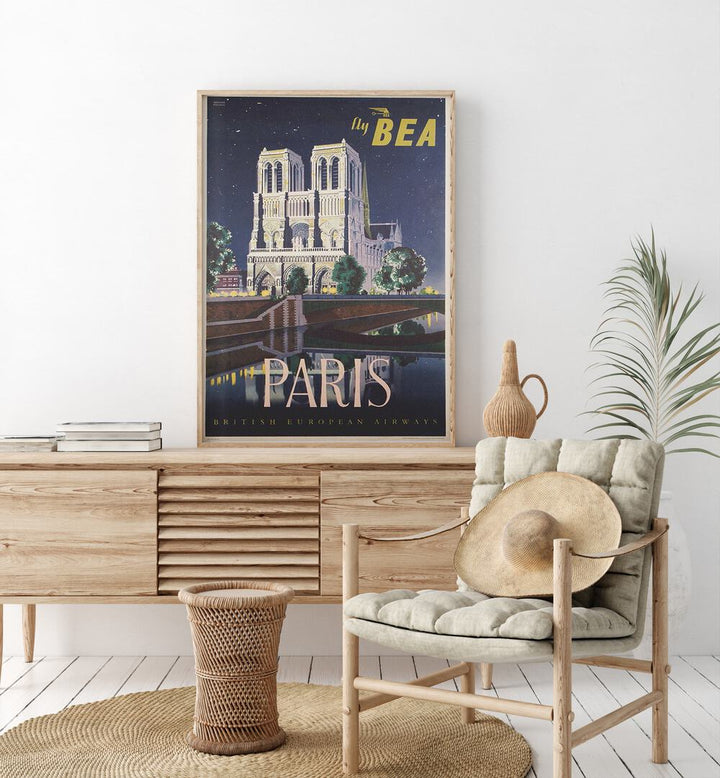 Paris-British European Airways  Vintage Travel Posters in Oak Wood Plain Frame placed on a console table behind a chair